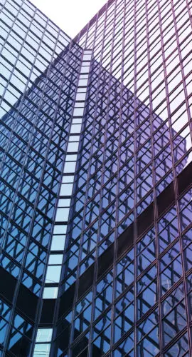 Interesting reflection and lines formed by two modern glass architecture.