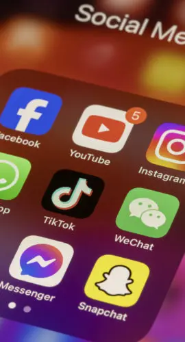 Portland, OR, USA - Nov 11, 2024: Some of the most popular social media apps by number of monthly active users, including Facebook, YouTube, Instagram, WhatsApp, TikTok, WeChat, Telegram, Messenger, and Snapchat, are seen on an iPhone.