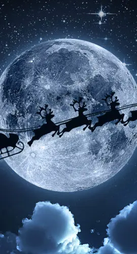 Santa flying in his sleigh against a full moon background with stars and clouds.