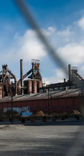 Abandoned Factory Through Fence View