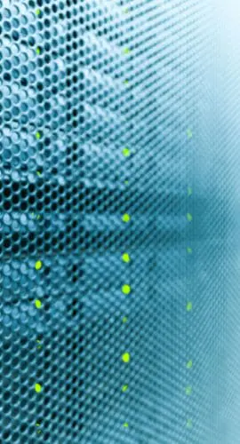 Macro detail of a perforated server rack panel with active green indicator lights in a data center, representing the operational infrastructure behind U.S. AI innovation and hyperscaler computing.
