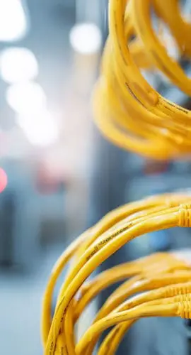 Yellow ethernet cables connected to network switch ports inside a data center, illustrating the physical network infrastructure supporting U.S. data center operations and AI-driven connectivity demands.