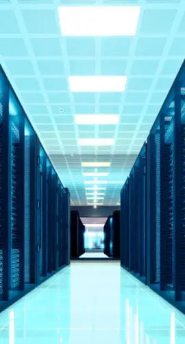 Interior corridor of a large-scale data center with rows of server racks, illustrating the infrastructure at the heart of U.S. data center development and AI-driven energy demand.