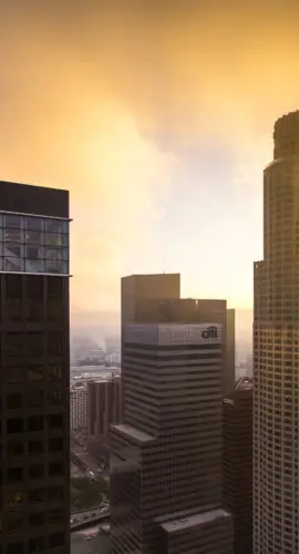 Still frame from time lapse 615130120. Shot taken from high up in a skyscraper in Downtown Los Angeles, of sunlight shining through fog and cloud, on the financial district.