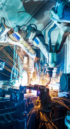 Robots welding in a car factory