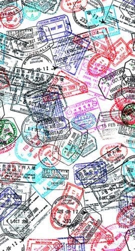 A collection of various colorful passport stamps overlapping each other.
